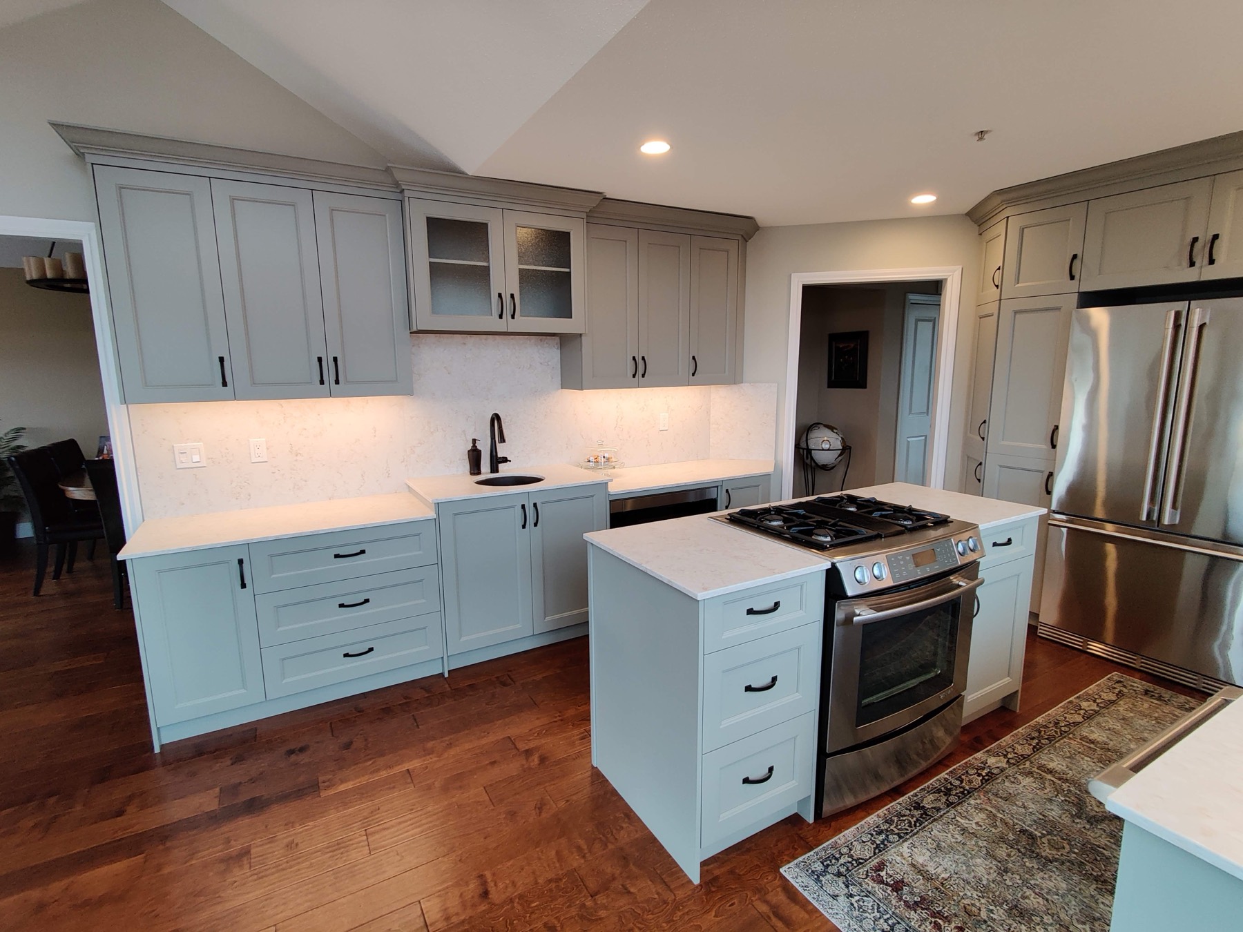 Renovated kitchen with shaker cabinetry, quartz counters and a gas range