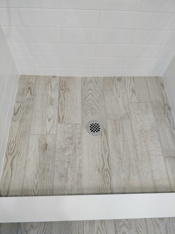 Tiled shower floor meeting the wall at a clean line