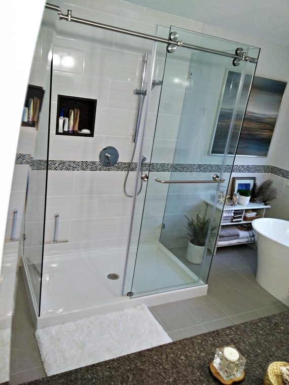Sliding glass door on a tiled shower enclosure with a niche